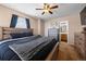 Bright main bedroom features a wood framed bed, view to the bathroom, and dresser storage at 13884 Lilac St, Thornton, CO 80602