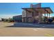 Exterior view of a Coach store entrance with modern architectural design and ample parking at 13884 Lilac St, Thornton, CO 80602
