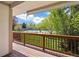 Backyard view from deck with green lawn and tennis court at 6213 S Galena Way, Englewood, CO 80111