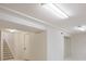 Spacious basement area featuring stairs, utility doors, and carpeted floors at 6213 S Galena Way, Englewood, CO 80111