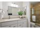 Bathroom featuring a vanity with a large mirror and a glass-enclosed shower at 6213 S Galena Way, Englewood, CO 80111