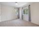 Bright, empty bedroom featuring neutral walls, carpeting, and two large windows at 6213 S Galena Way, Englewood, CO 80111