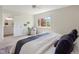 Bright bedroom featuring a ceiling fan, window with natural light, and attached bathroom with vanity at 6213 S Galena Way, Englewood, CO 80111