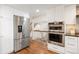 Bright kitchen features stainless steel appliances and hardwood floors at 6213 S Galena Way, Englewood, CO 80111