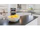 Modern kitchen featuring white cabinetry, stainless appliances, and dark countertops at 6213 S Galena Way, Englewood, CO 80111