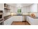 Bright kitchen features white cabinets, stainless steel appliances, and hardwood floors at 6213 S Galena Way, Englewood, CO 80111