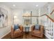 Spacious living area features hardwood floors, staircase, and open access to kitchen at 6213 S Galena Way, Englewood, CO 80111
