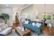 Cozy living room with fireplace, open floorplan and a view of the dining room and staircase at 6213 S Galena Way, Englewood, CO 80111