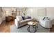 Bright living room featuring hardwood floors, stylish furniture, and an open floor plan at 6213 S Galena Way, Englewood, CO 80111