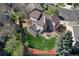Aerial shot of home with deck, patio, and fenced yard in a leafy neighborhood at 12646 S Dove Creek Way, Parker, CO 80134