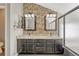 Stylish bathroom featuring dual sinks with vessel bowls, a granite countertop, and a tiled accent wall at 12646 S Dove Creek Way, Parker, CO 80134