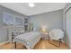 Comfortable bedroom featuring a desk, large window, and a cozy chair at 12646 S Dove Creek Way, Parker, CO 80134