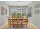 Bright dining room with wood floors, a decorative chandelier, and a large window overlooking the backyard at 12646 S Dove Creek Way, Parker, CO 80134