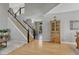 Welcoming entryway featuring hardwood floors, a staircase with dark railings, and an open floor plan at 12646 S Dove Creek Way, Parker, CO 80134