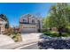 Charming two-story home featuring stone accents, a well-manicured lawn, and a two-car garage at 12646 S Dove Creek Way, Parker, CO 80134
