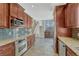 Updated kitchen boasts granite countertops, stainless steel appliances, and a seamless transition into the breakfast bar, blending style and functionality at 12646 S Dove Creek Way, Parker, CO 80134