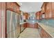 Spacious kitchen features stainless steel appliances, granite countertops, and dark wood cabinets, creating a gourmet cooking experience at 12646 S Dove Creek Way, Parker, CO 80134