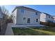 View of the backyard with a concrete patio and fire pit at 5956 S Winnipeg St, Aurora, CO 80015