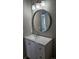 Contemporary bathroom featuring a sleek vanity with a round mirror at 5956 S Winnipeg St, Aurora, CO 80015