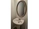 Half bathroom with decorative mirror above pedestal sink at 5956 S Winnipeg St, Aurora, CO 80015