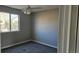 Cozy bedroom featuring a window for natural light and plush carpeting at 5956 S Winnipeg St, Aurora, CO 80015