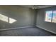 Sunlit bedroom features plush carpet and a large window at 5956 S Winnipeg St, Aurora, CO 80015