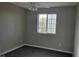 Cozy bedroom featuring a window for natural light and plush carpeting at 5956 S Winnipeg St, Aurora, CO 80015