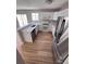 Modern kitchen features stainless steel appliances, white cabinets, and ample counter space at 5956 S Winnipeg St, Aurora, CO 80015