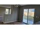 Bright living room with modern ceiling fan and sliding glass door at 5956 S Winnipeg St, Aurora, CO 80015