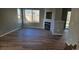 Bright living room with hardwood floors, a large window, and a modern fireplace at 5956 S Winnipeg St, Aurora, CO 80015