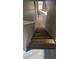 Staircase with modern wood steps, carpeted landing, and natural light at 5956 S Winnipeg St, Aurora, CO 80015