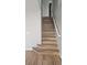 Hardwood stairs with white railings lead to the upper level of the home at 5956 S Winnipeg St, Aurora, CO 80015