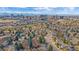 An aerial shot featuring a residential community with views of a vibrant cityscape skyline in the distance at 8690 E Chenango Ave, Denver, CO 80237