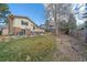 Large back yard showing grass, patio, garden, and brick siding of home at 8690 E Chenango Ave, Denver, CO 80237