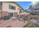 Backyard patio with red pavers, seating area and a grill at 8690 E Chenango Ave, Denver, CO 80237