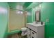 Basement bathroom with colorful tile and an updated vanity at 8690 E Chenango Ave, Denver, CO 80237