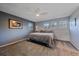 Cozy bedroom features soft carpet, a ceiling fan, and natural light from multiple windows at 8690 E Chenango Ave, Denver, CO 80237