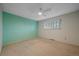 Clean bedroom features soft carpet, neutral paint and natural light from the large window at 8690 E Chenango Ave, Denver, CO 80237