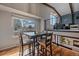 Inviting dining area featuring a modern table, with backyard views, and loft access at 8690 E Chenango Ave, Denver, CO 80237