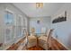 Cozy dining room featuring hardwood floors and natural light from multiple windows at 8690 E Chenango Ave, Denver, CO 80237