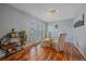 Bright dining room with hardwood floors, large windows, and decorative plant shelving at 8690 E Chenango Ave, Denver, CO 80237