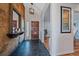 Welcoming entryway with dark tile flooring, wood accents, and a view into the living spaces at 8690 E Chenango Ave, Denver, CO 80237