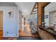 Inviting entryway with hardwood floors, stairs leading to the upper level, and open sightlines at 8690 E Chenango Ave, Denver, CO 80237