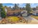 Charming two-story home featuring a brick facade, attached garage, and a well-maintained lawn at 8690 E Chenango Ave, Denver, CO 80237