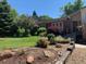 Landscaped front yard featuring an arrangement of shrubs and stone at 8690 E Chenango Ave, Denver, CO 80237