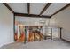 Open-concept home featuring exposed ceiling beams and overlooking dining area at 8690 E Chenango Ave, Denver, CO 80237