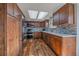 Modern kitchen featuring stainless steel appliances, custom cabinetry, and decorative backsplash at 8690 E Chenango Ave, Denver, CO 80237