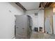 Unfinished laundry room featuring a modern front-loading washer and dryer set at 8690 E Chenango Ave, Denver, CO 80237
