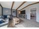Comfortable living room featuring exposed beams and a gray sectional sofa at 8690 E Chenango Ave, Denver, CO 80237