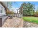 Wooden deck in backyard with seating, string lights, and a well-maintained lawn at 1920 S Downing St, Denver, CO 80210